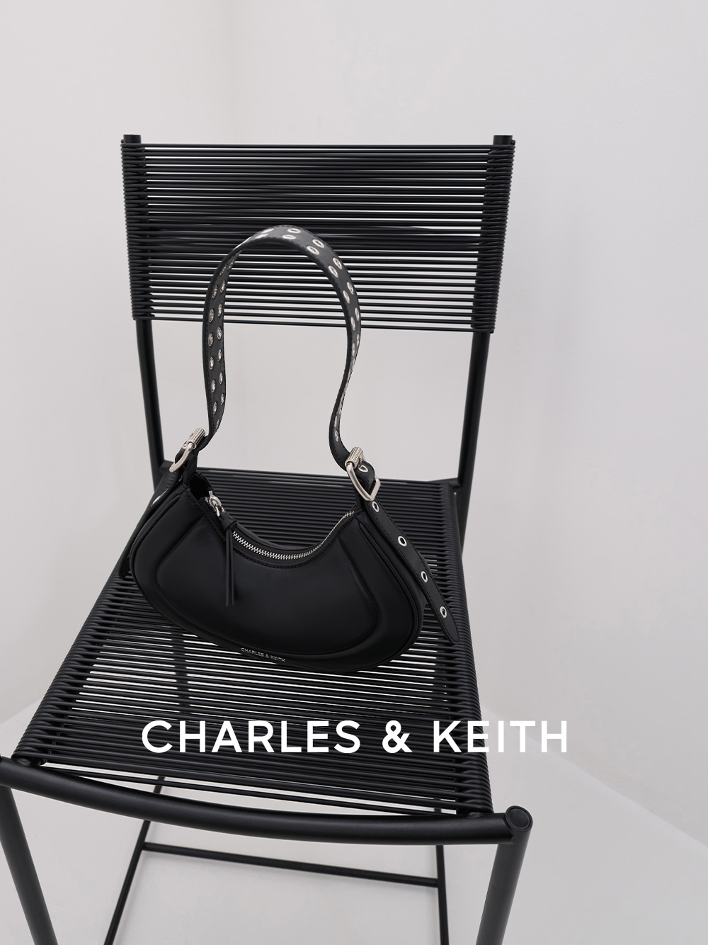 Petra Grommet-Strap Curved Shoulder Bag in black - CHARLES & KEITH