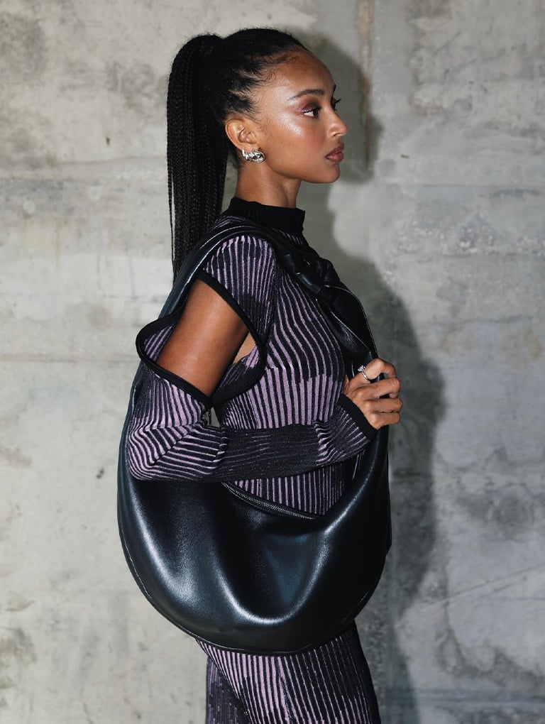 Women’s Toni knotted curved hobo bag in noir & Robbie platform knee-high boots in black, as seen on Tade - CHARLES & KEITH