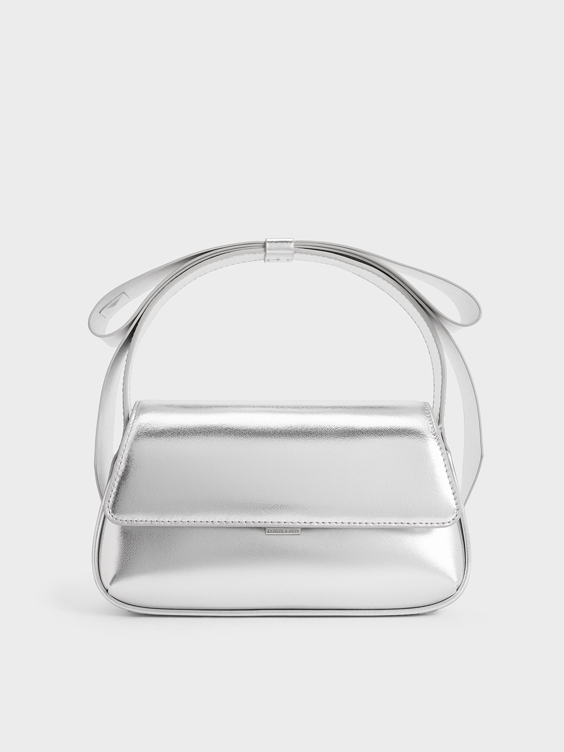 Shop Charles & Keith Leather Metallic Bow Top-handle Bag In Silver