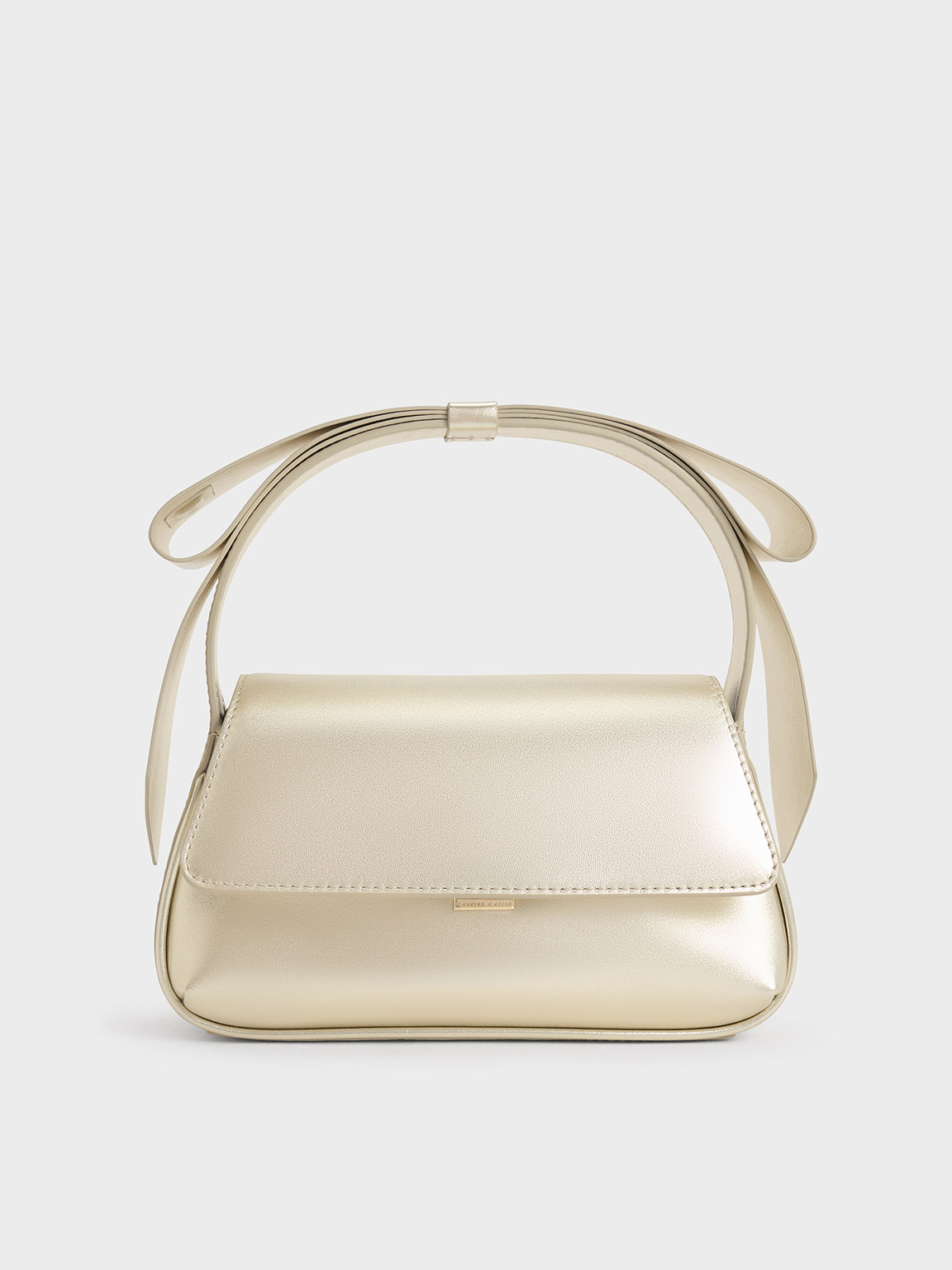 Shop Charles & Keith - Leather Metallic Bow Top-handle Bag In Champagne